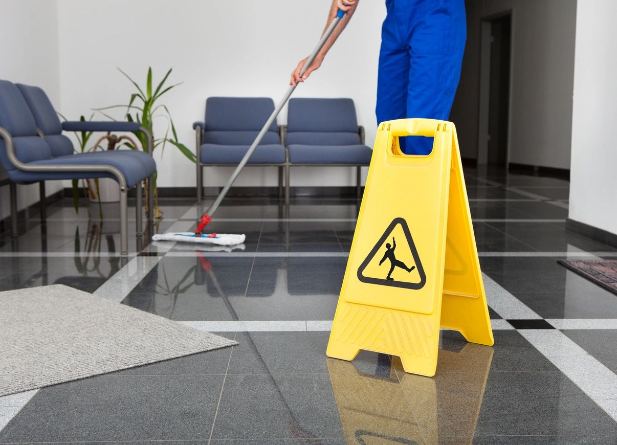 Commercial cleaner mopping a professional lobby