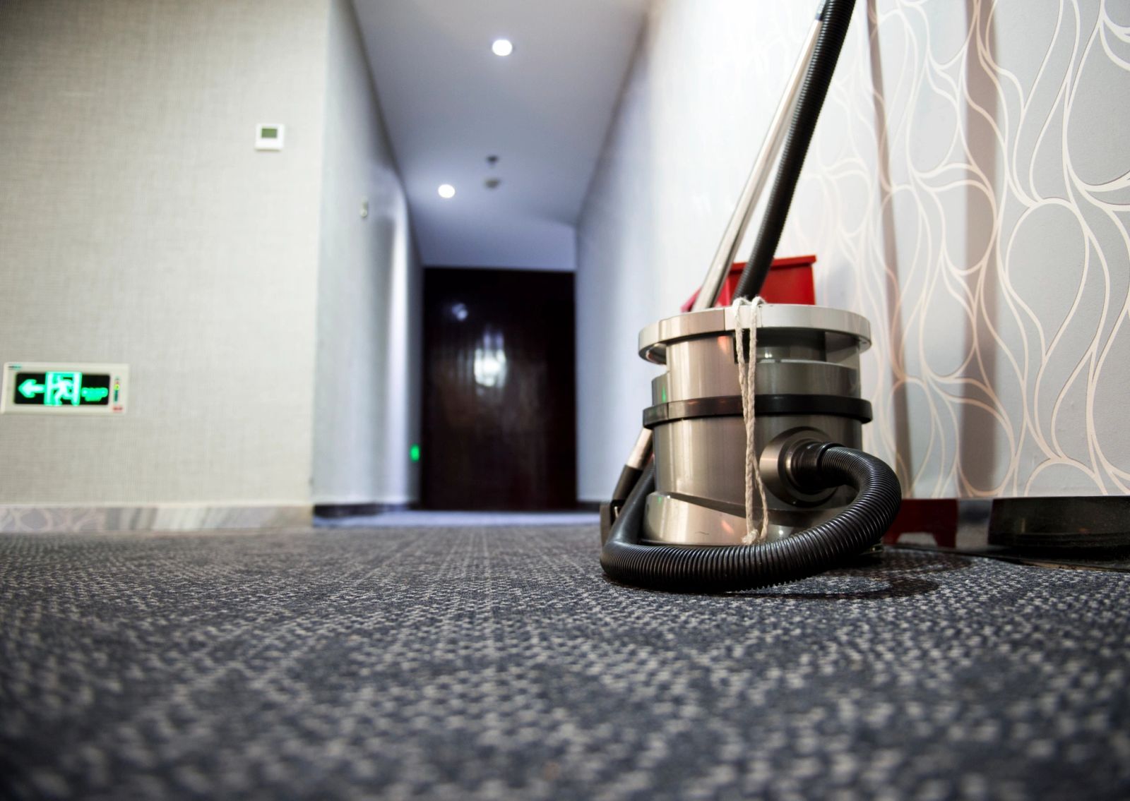 Commercial vacuuming equipment in a clean hallway